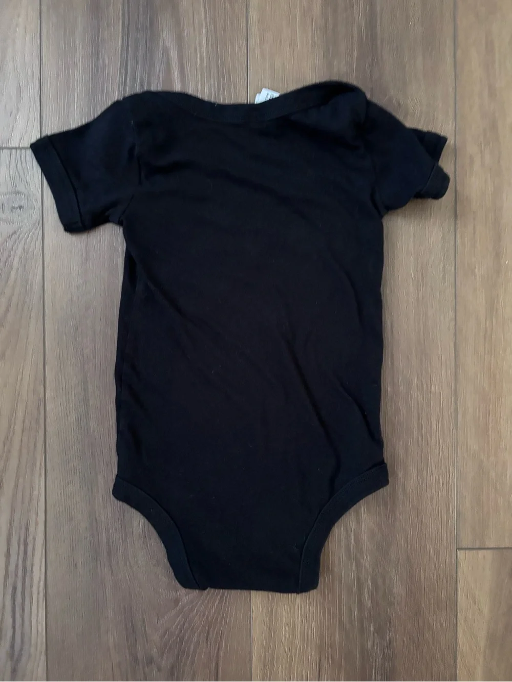 Bella Canvas Black Baby One-Piece with Yellow Smiley and White Graphic